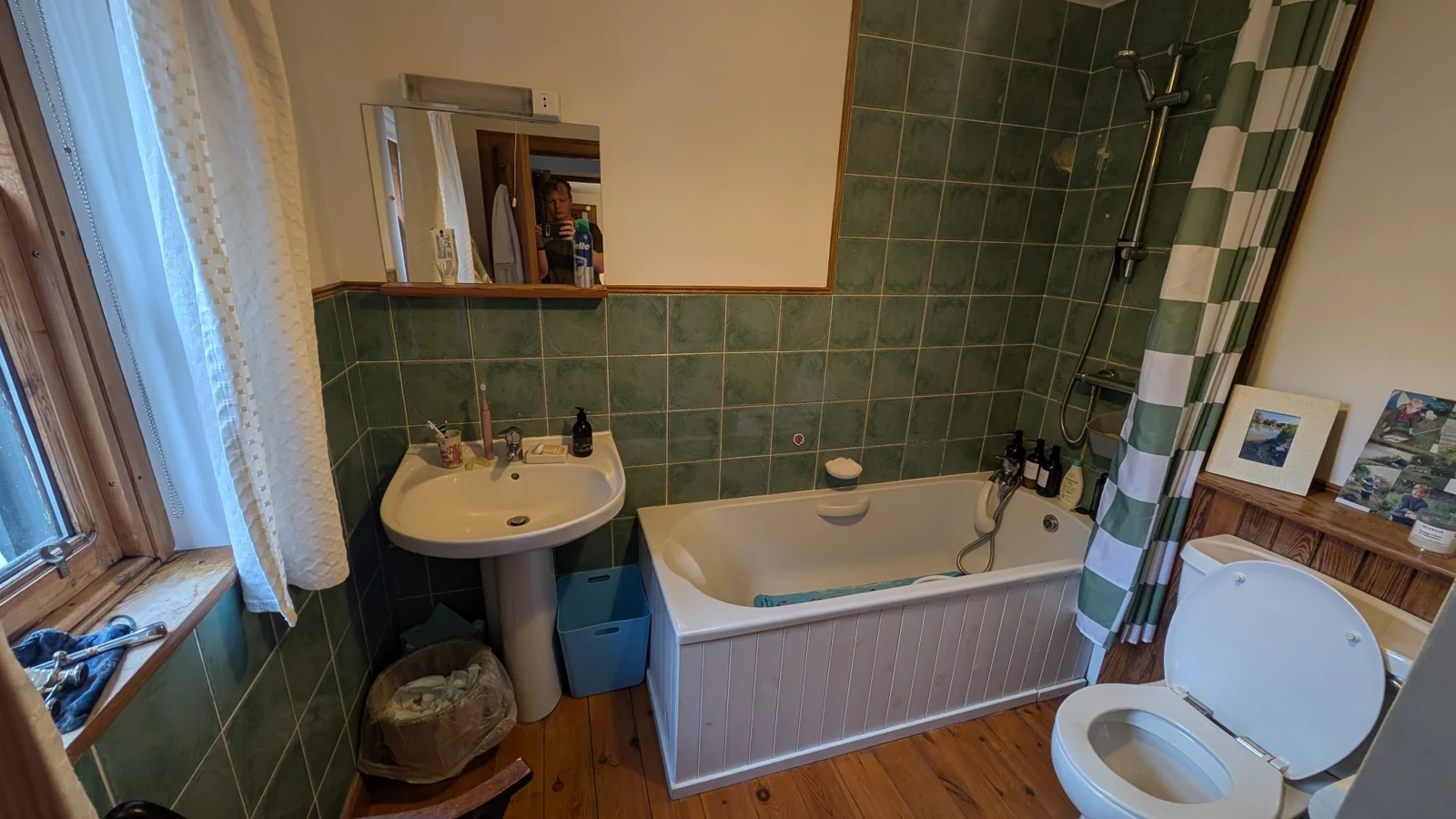 Bathroom with a bath, shower over the bath, basin and toilet