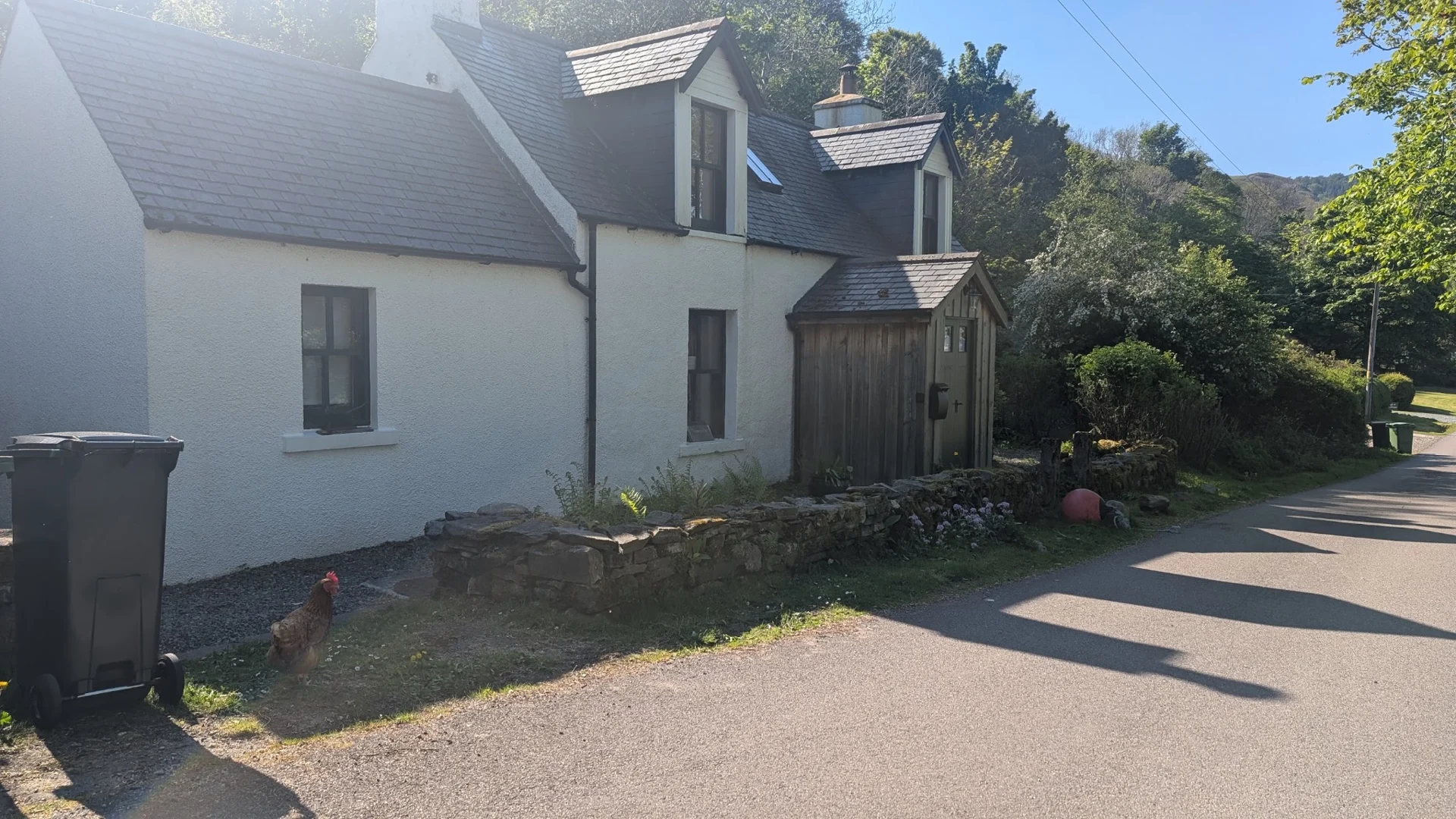 White cottage beside the quiet road in Letterfearn