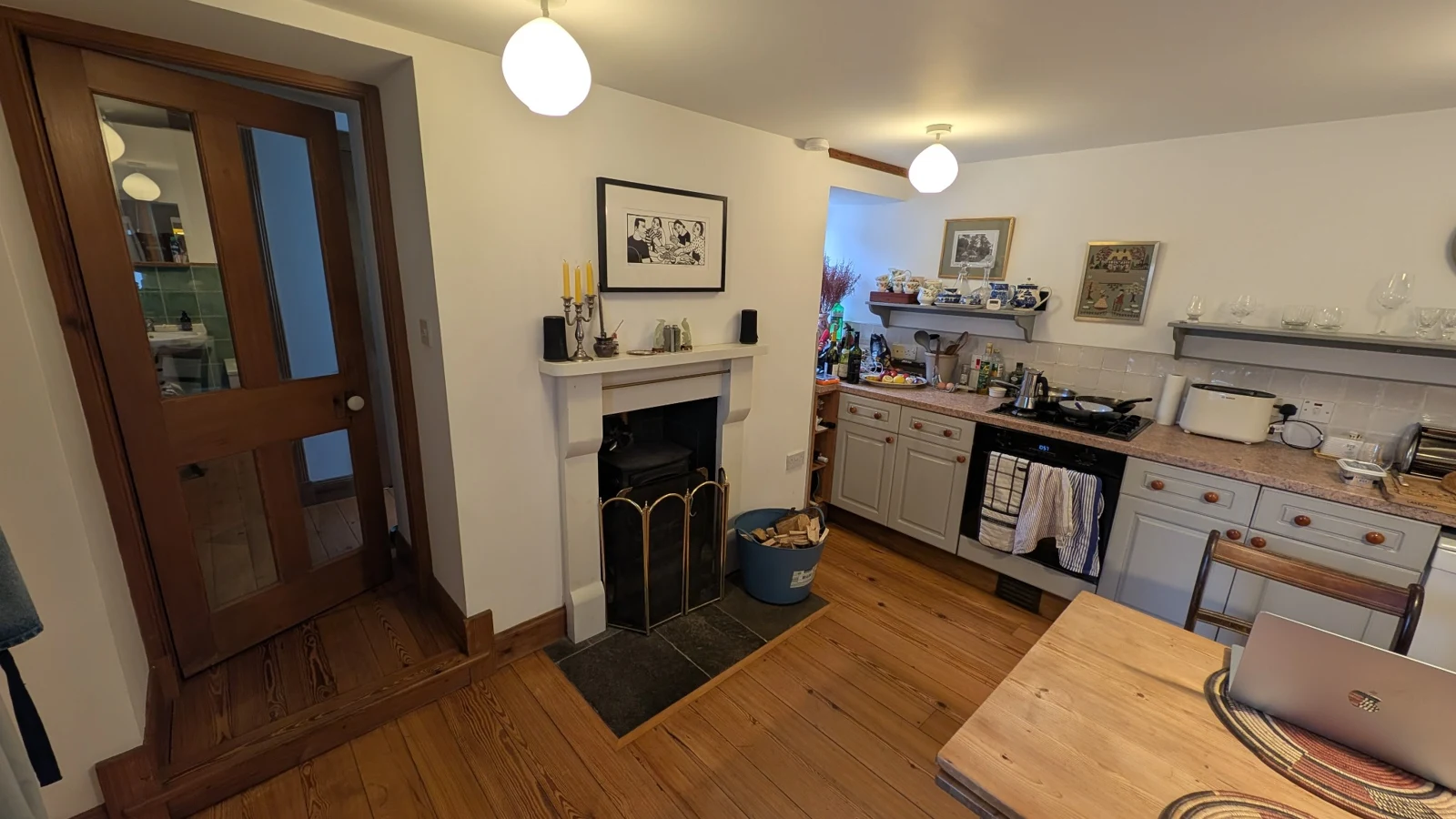 Cottage kitchen with a dining table, cooker and woodburning stove