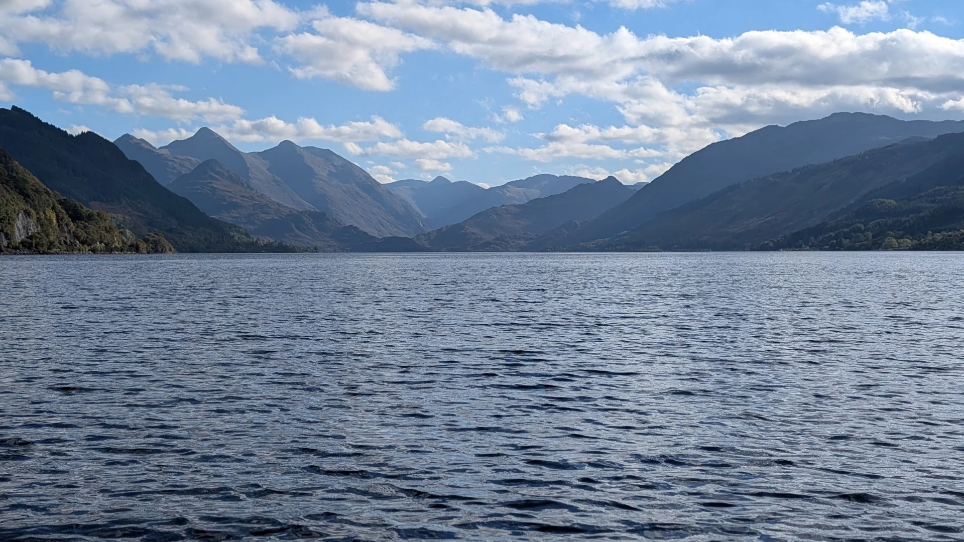 Blue water and layers of mountain ridges around Loch Duich